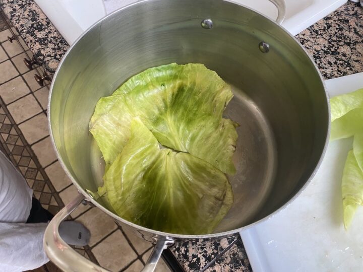 Lining the pot for dolma with cabbage