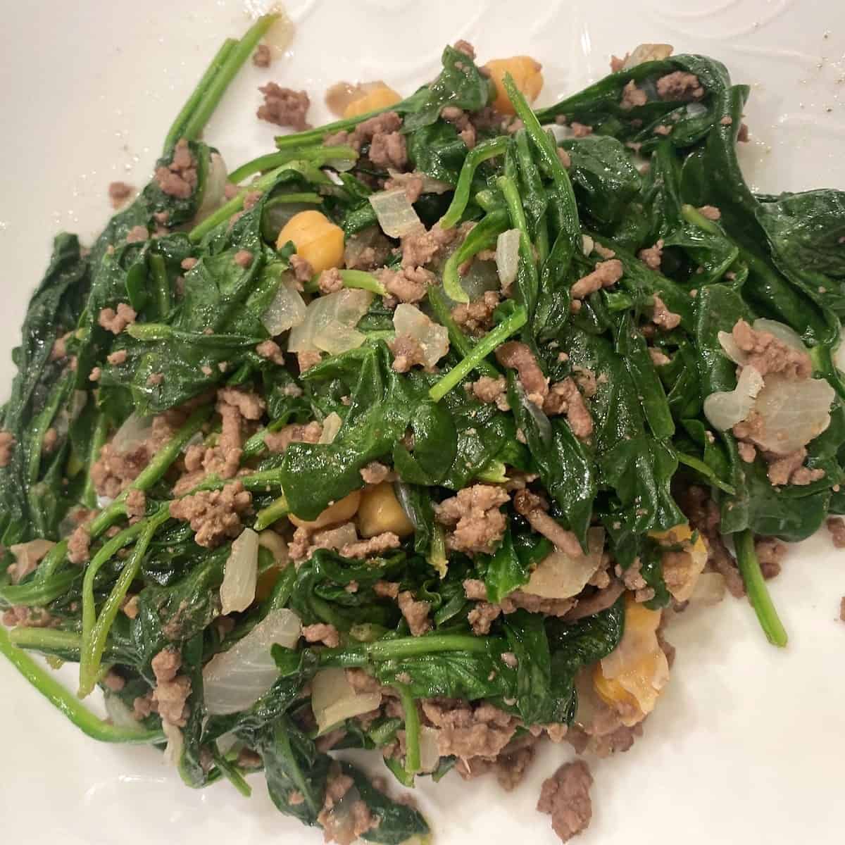 Spinach garbanzo bean stew on a white plate