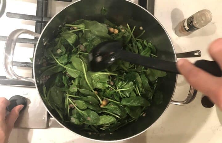 Wilting the spinach for the garbanzo bean stew