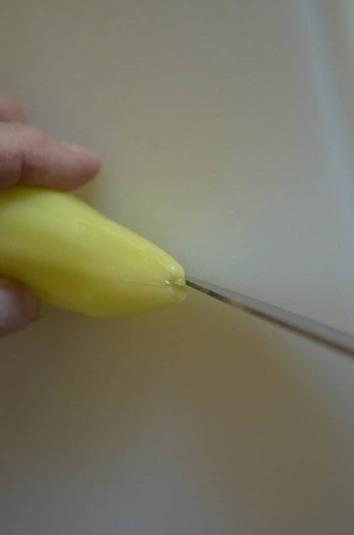 Scoring yellow pepper for Pickled Armenian cucumbers