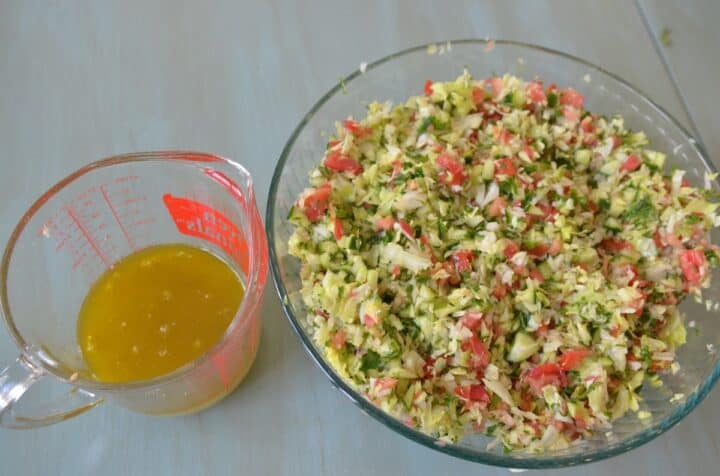 Dressing in a glass measuring cup for grain-free tabouli salad