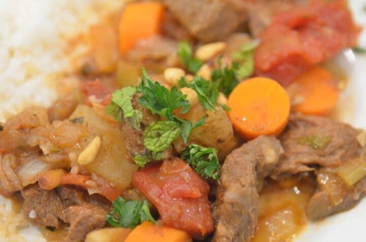 A close-up of middle eastern lamb stew garnished with parsley