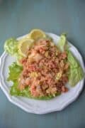 Tomato and onion bulgur salad on a bed of lettuce