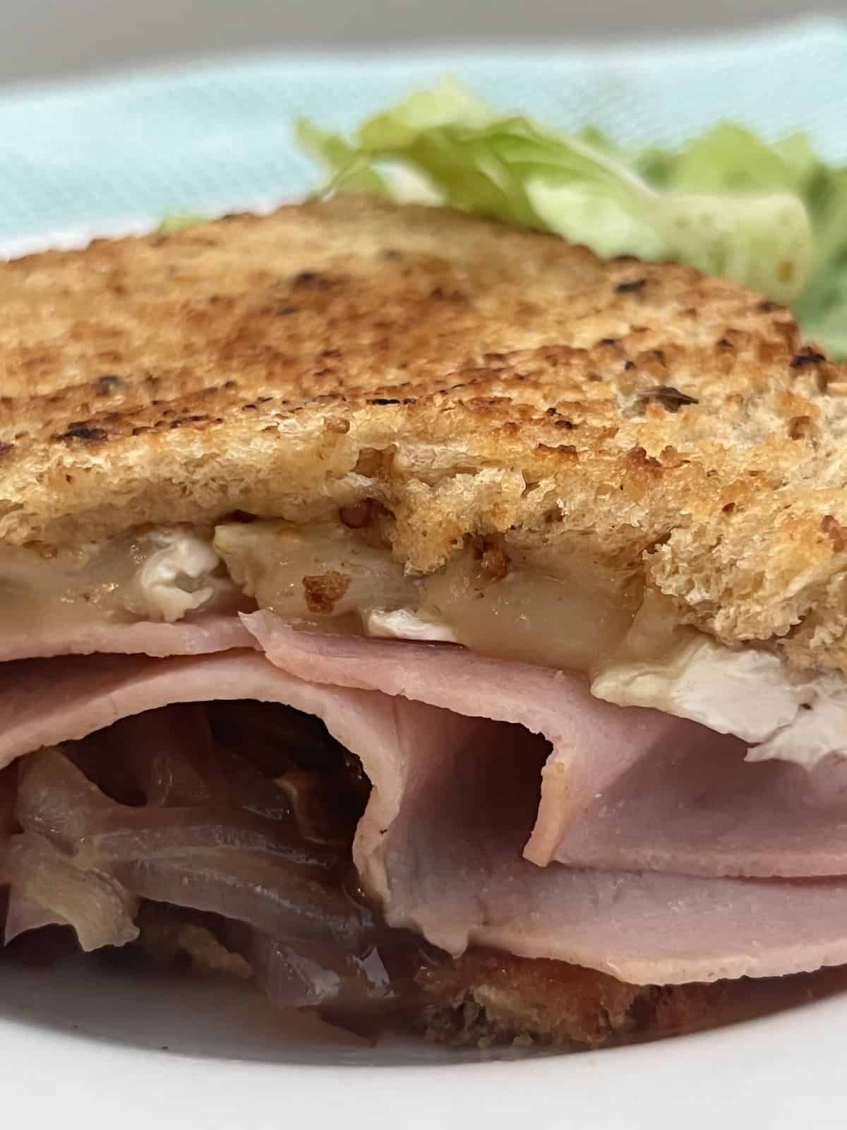 Brie Grilled Cheese sandwich with ham, red onion and fig jam.
